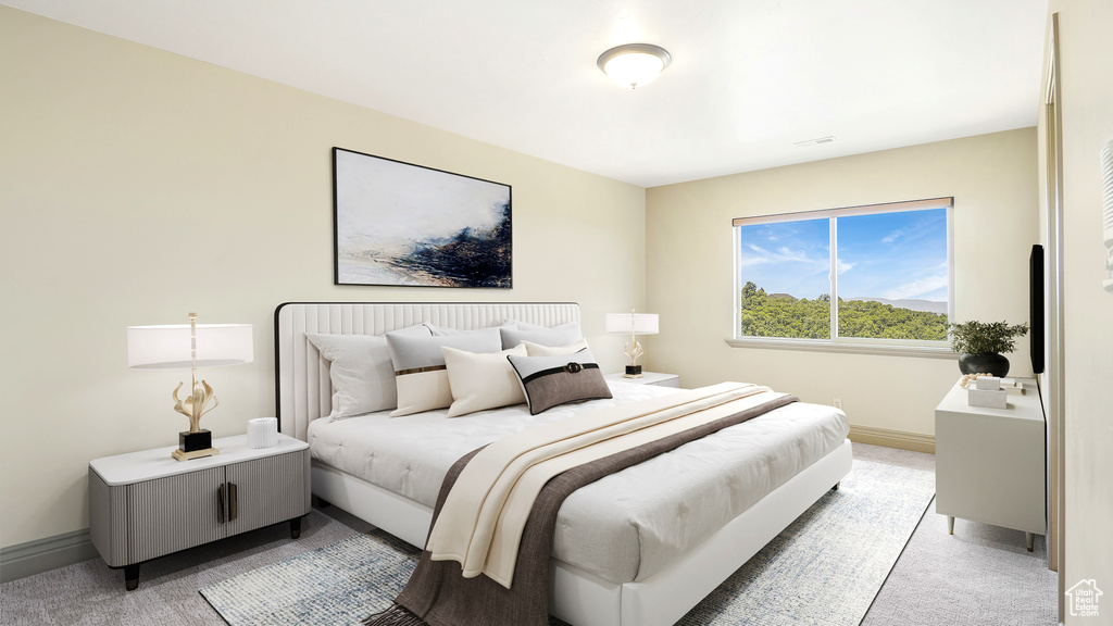 Bedroom with light carpet and baseboards