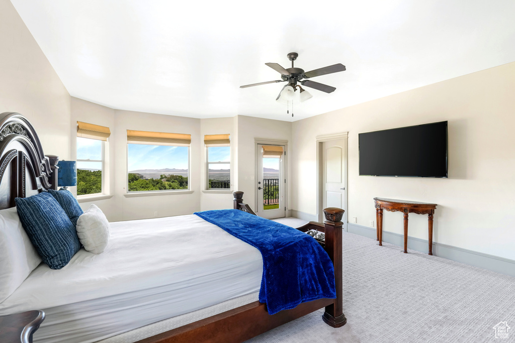 Carpeted bedroom featuring baseboards and ceiling fan