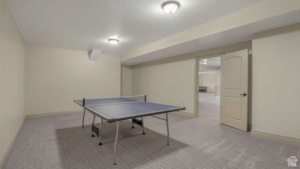 Game room featuring light carpet and baseboards