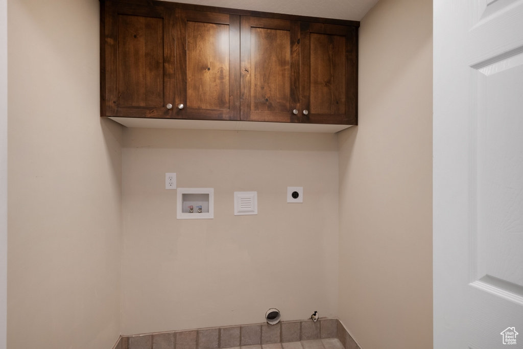 Laundry room featuring hookup for a washing machine, electric dryer hookup, cabinet space, and hookup for a gas dryer