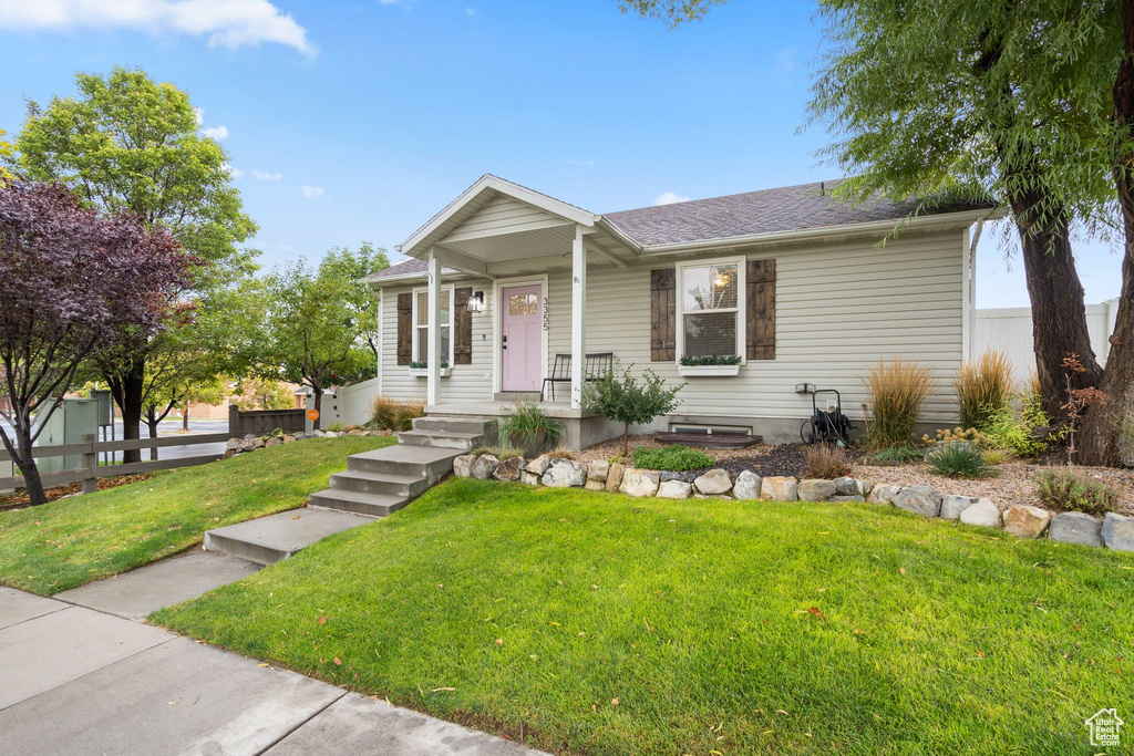 View of front of house with a shingled roof