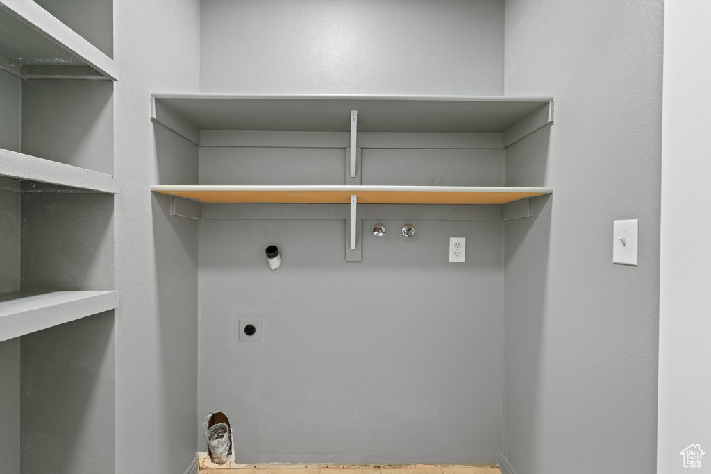 Washroom featuring electric dryer hookup, hookup for a gas dryer, and baseboards