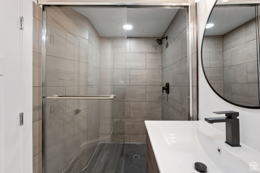 Full bathroom featuring a stall shower and vanity
