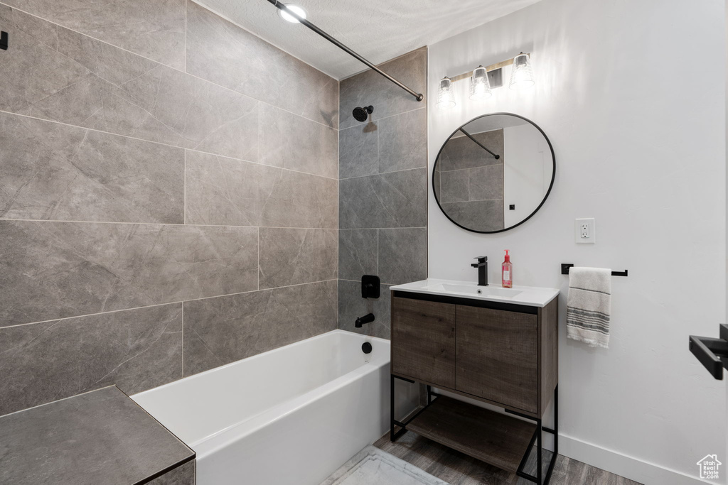 Full bathroom featuring  shower combination, vanity, and baseboards