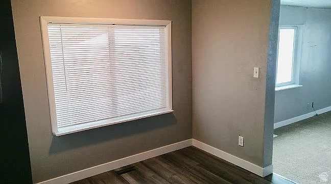 Detailed view of baseboards and wood finished floors
