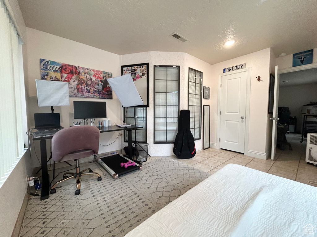 Home office with tile patterned floors and baseboards