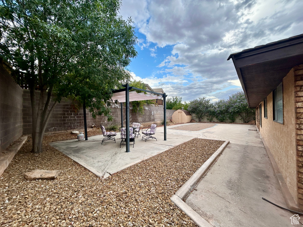 Fenced backyard with a patio area