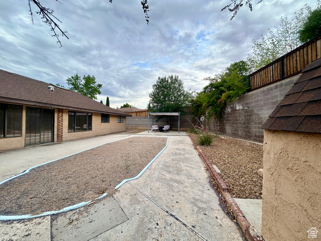Fenced backyard with a patio