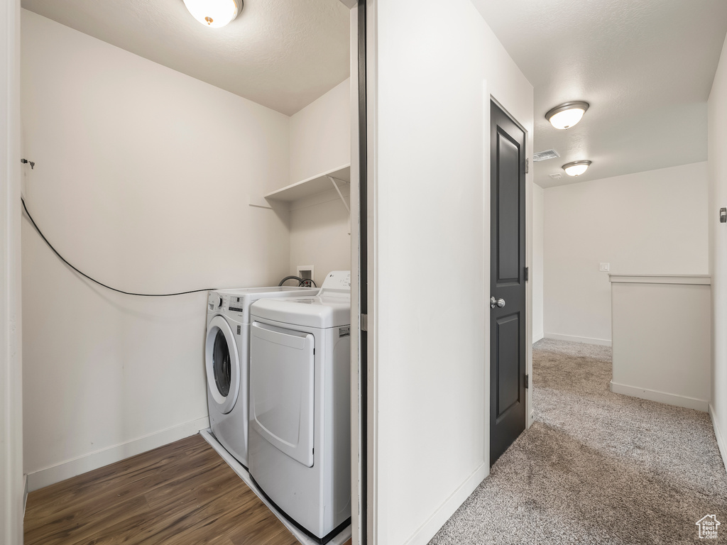 Laundry area with washing machine and clothes dryer and baseboards
