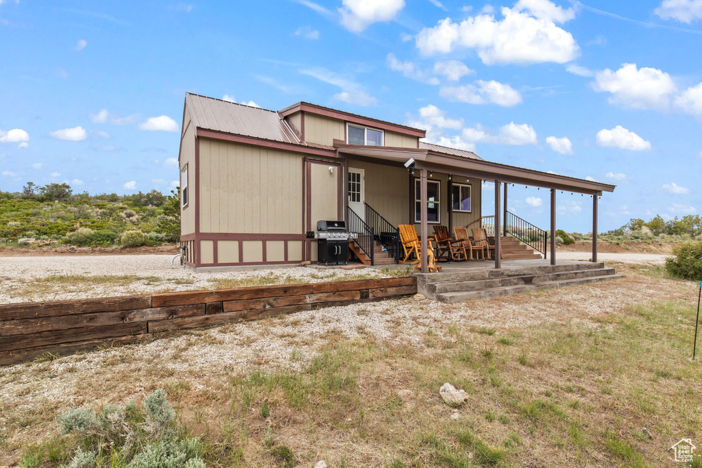 Back of house with metal roof