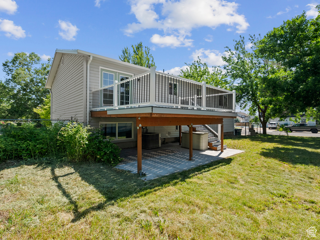 Back of property with a patio, stairway, and a deck