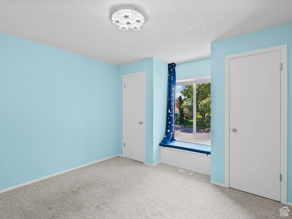 Unfurnished bedroom featuring carpet flooring and baseboards
