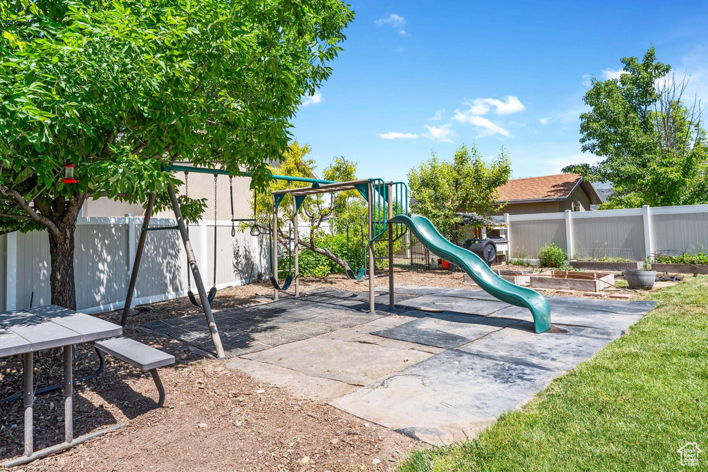 Community playground with a fenced backyard