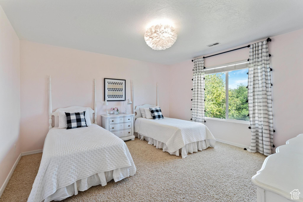 Bedroom featuring baseboards and light colored carpet