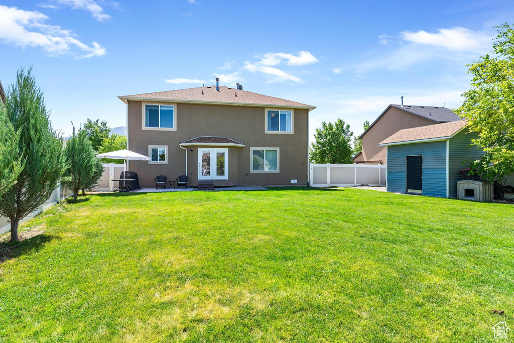 Rear view of property featuring a patio, french doors, and stucco siding
