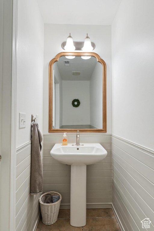 Bathroom with wainscoting and a sink
