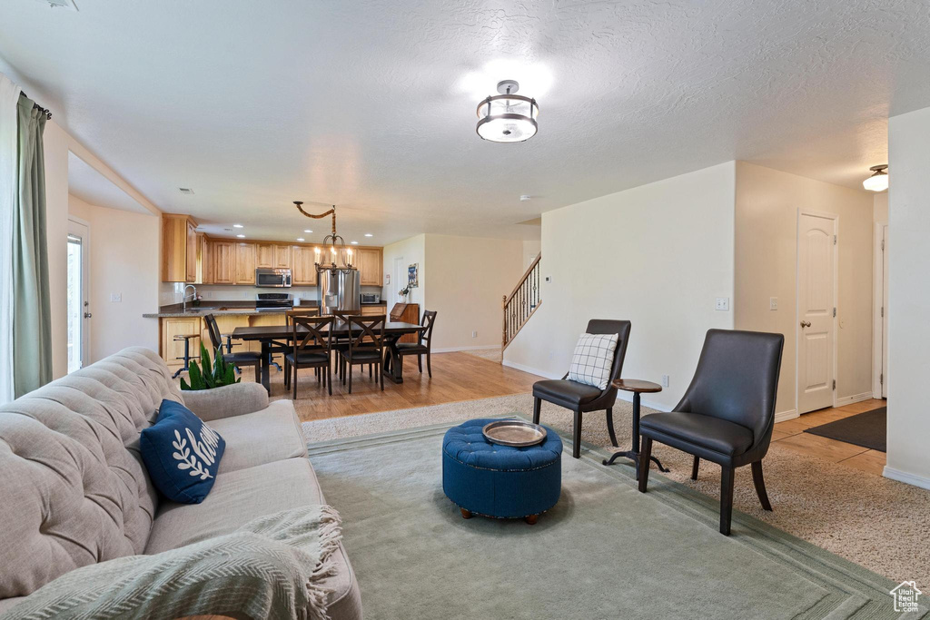 Living area featuring stairs, baseboards, and recessed lighting