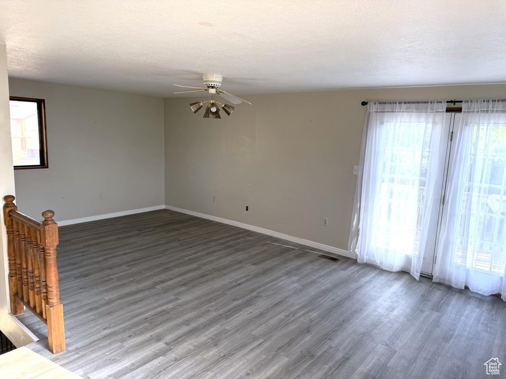 Empty room featuring wood finished floors and ceiling fan