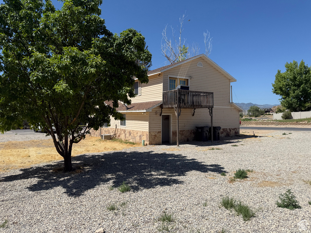 View of side of home featuring stone siding