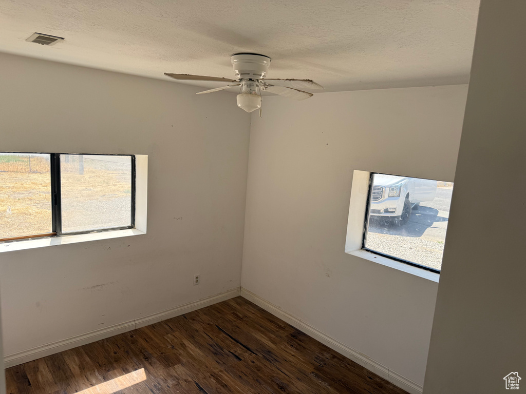 Spare room featuring wood finished floors and a ceiling fan