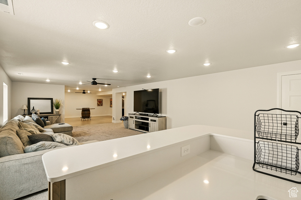 Living room with recessed lighting, a ceiling fan, and baseboards