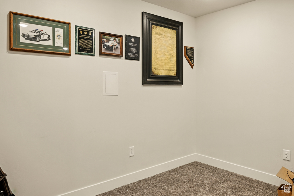 Empty room with baseboards and carpet flooring