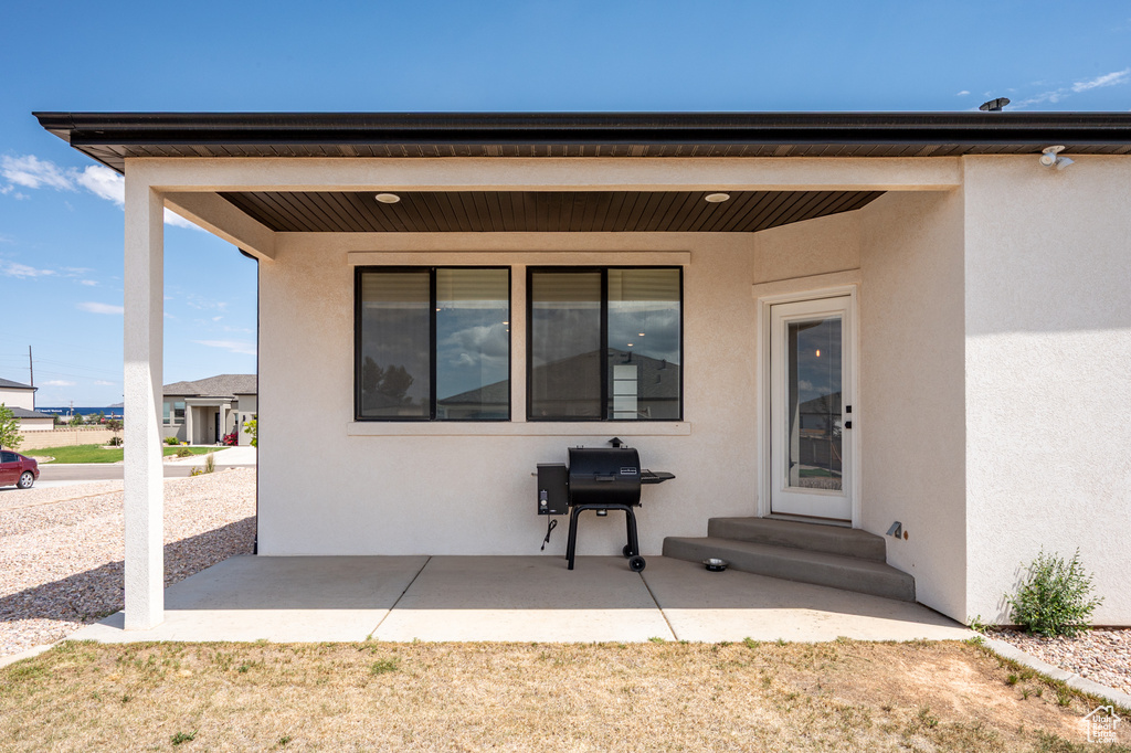 Rear view of property featuring stucco siding and a patio area