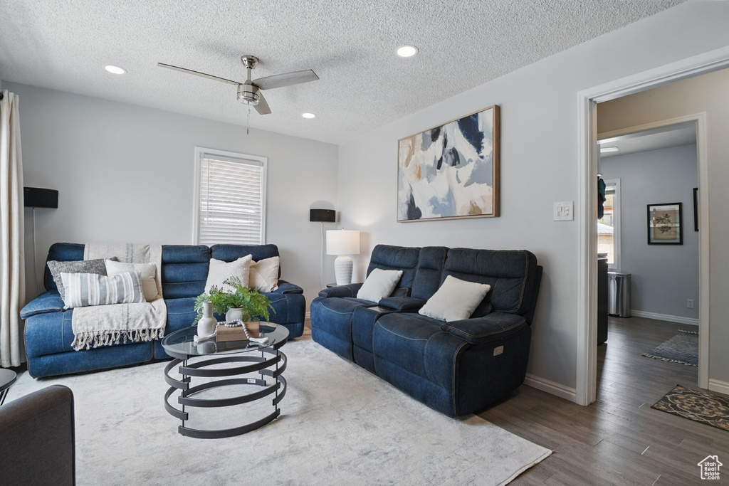 Living area featuring healthy amount of natural light, ceiling fan, wood finished floors, a textured ceiling, and recessed lighting