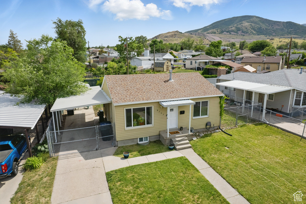 Bungalow-style house featuring a residential view, a mountain view, a gate, and a shingled roof