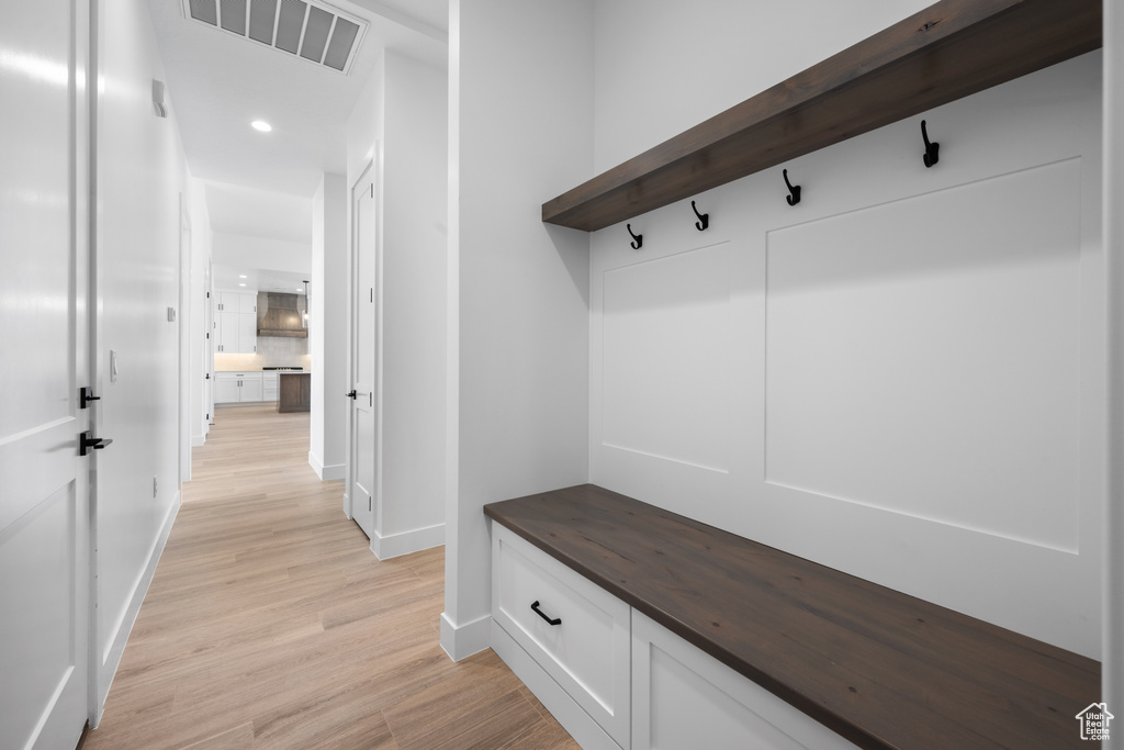 Mudroom featuring baseboards, light wood-type flooring, and recessed lighting