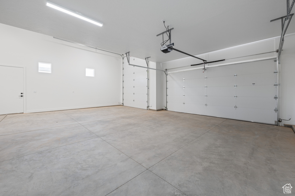 Garage featuring a garage door opener