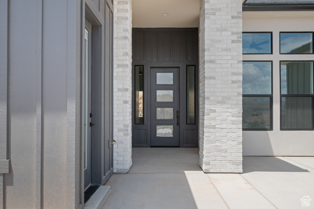 View of exterior entry featuring board and batten siding