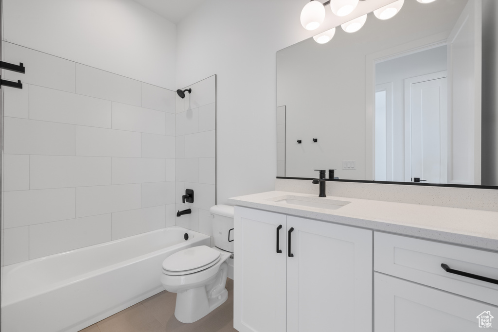 Bathroom featuring vanity, toilet, shower / bathtub combination, and tile patterned flooring
