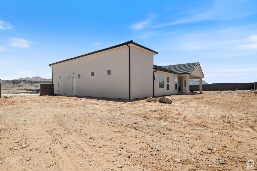 Rear view of house featuring a mountain view