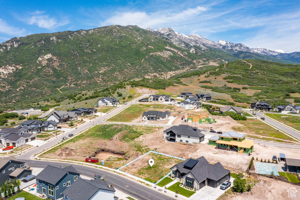 Aerial perspective of suburban area with a mountain backdrop and property boundaries highlighted