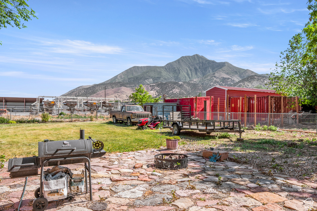 View of yard featuring a fire pit and a mountain view