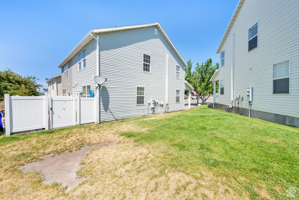 Back of property with a gate