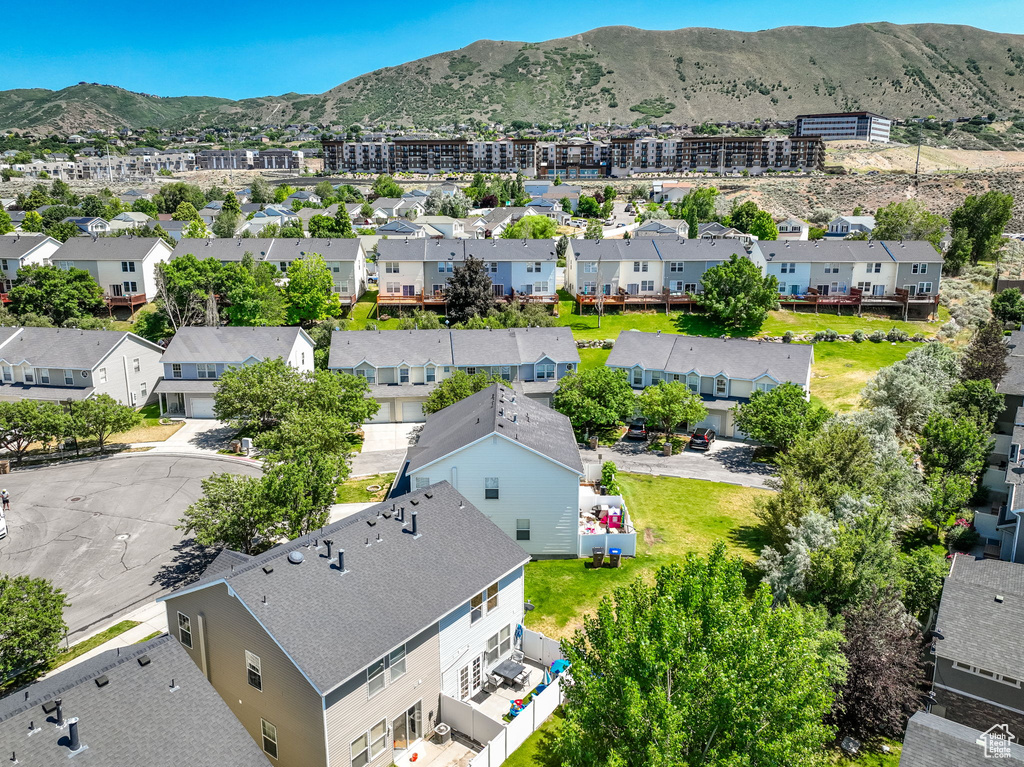 Aerial view of residential area featuring a mountainous background