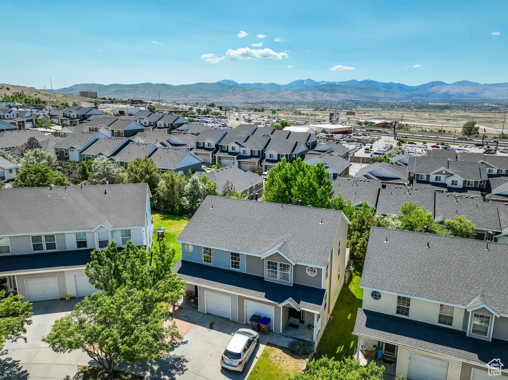 Aerial perspective of suburban area with a mountainous background