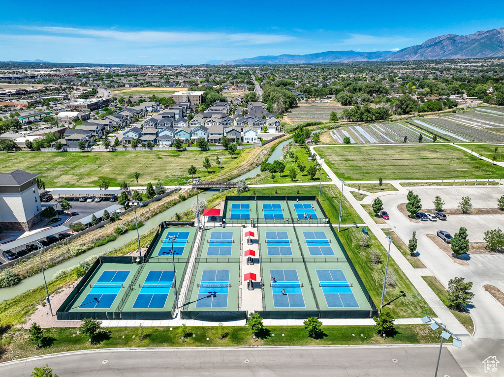 Aerial view of residential area with a mountainous background and a pool area