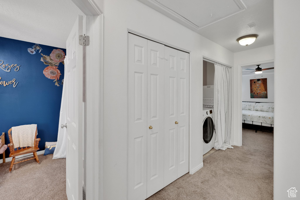 Laundry area with light carpet, attic access, washer / clothes dryer, and ceiling fan