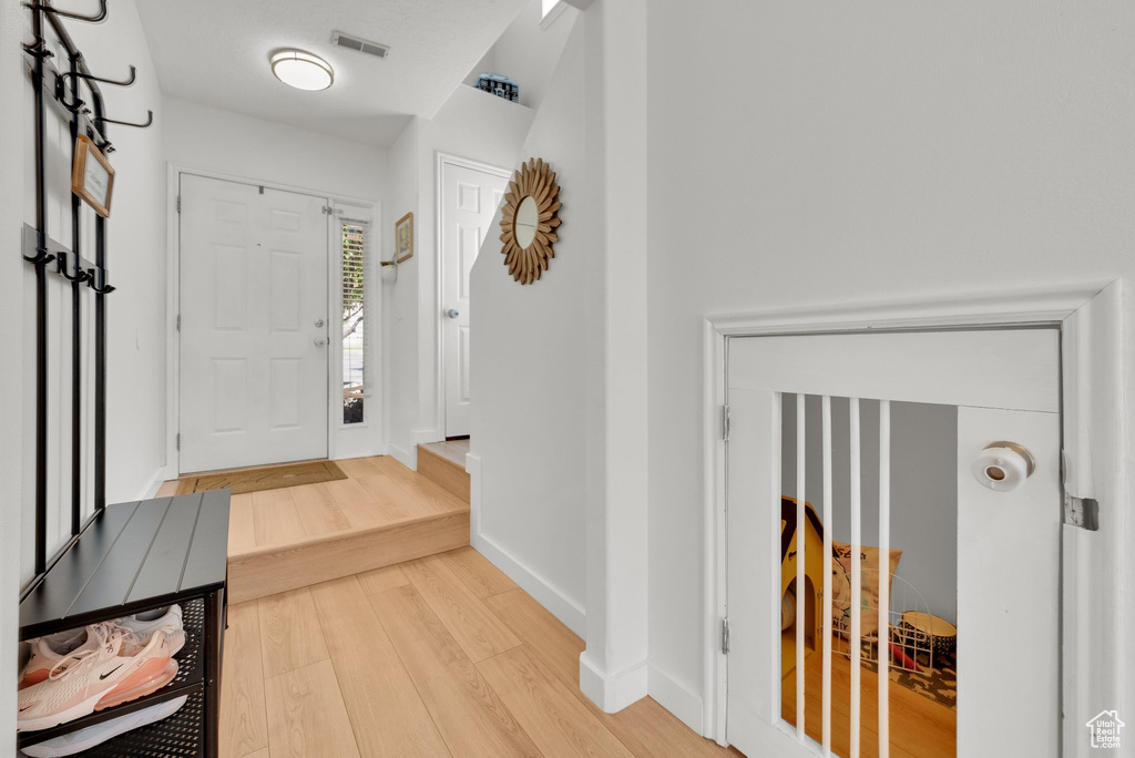 Entryway featuring light wood-style floors and baseboards