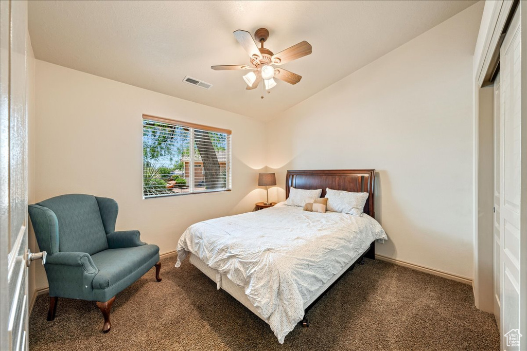 Bedroom with carpet, lofted ceiling, a closet, a ceiling fan, and baseboards
