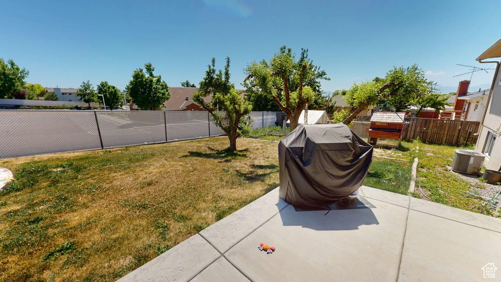 View of yard with a patio area and central AC
