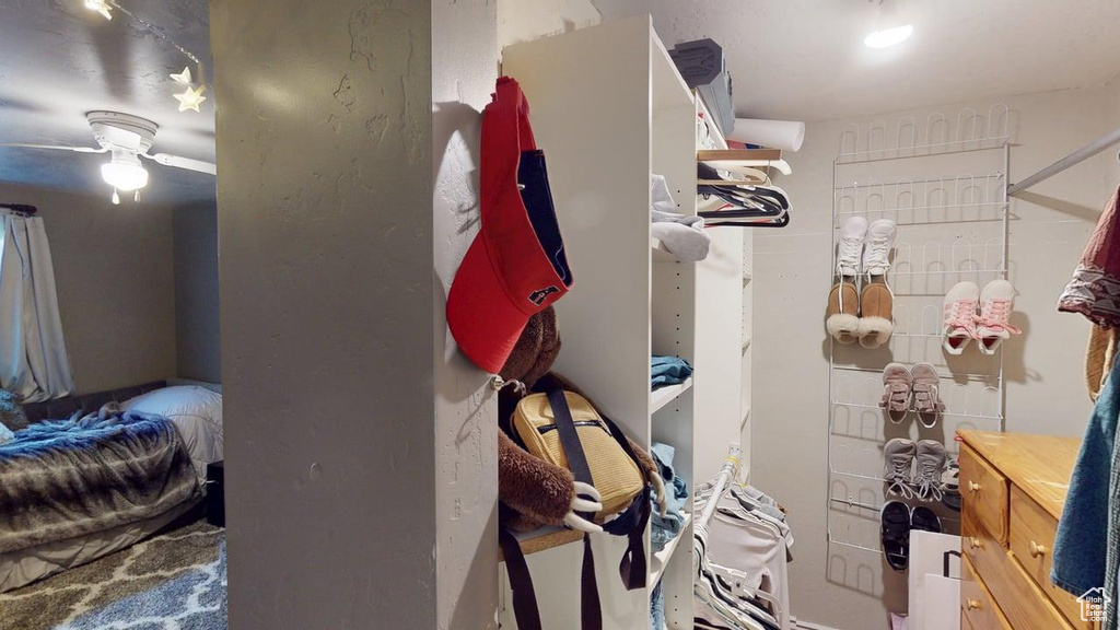 Spacious closet featuring a ceiling fan