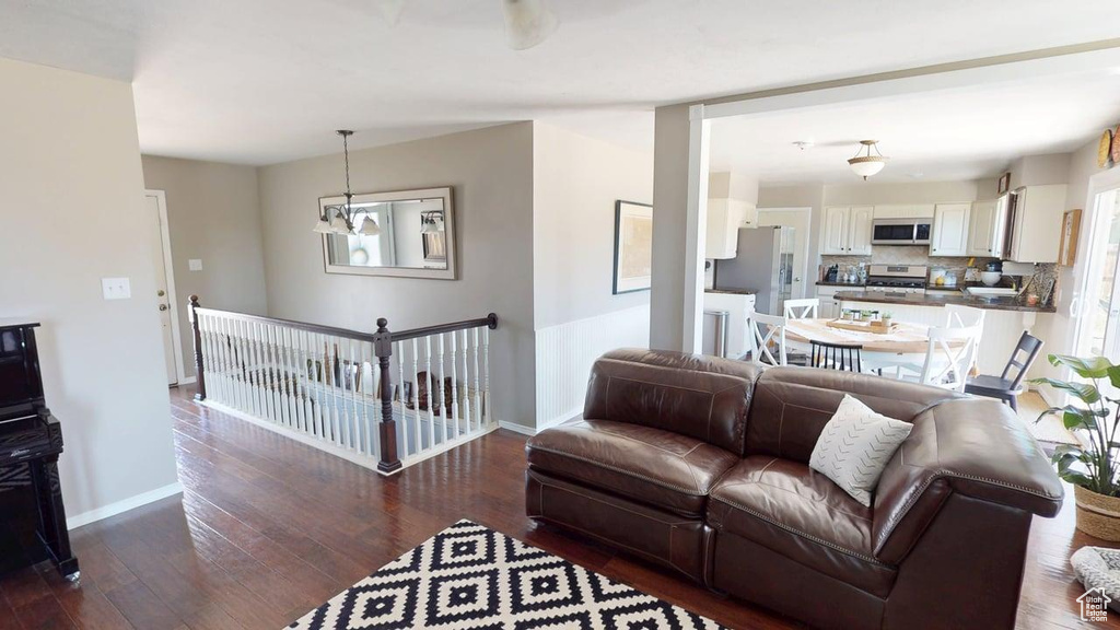 Living room featuring baseboards and dark wood-type flooring