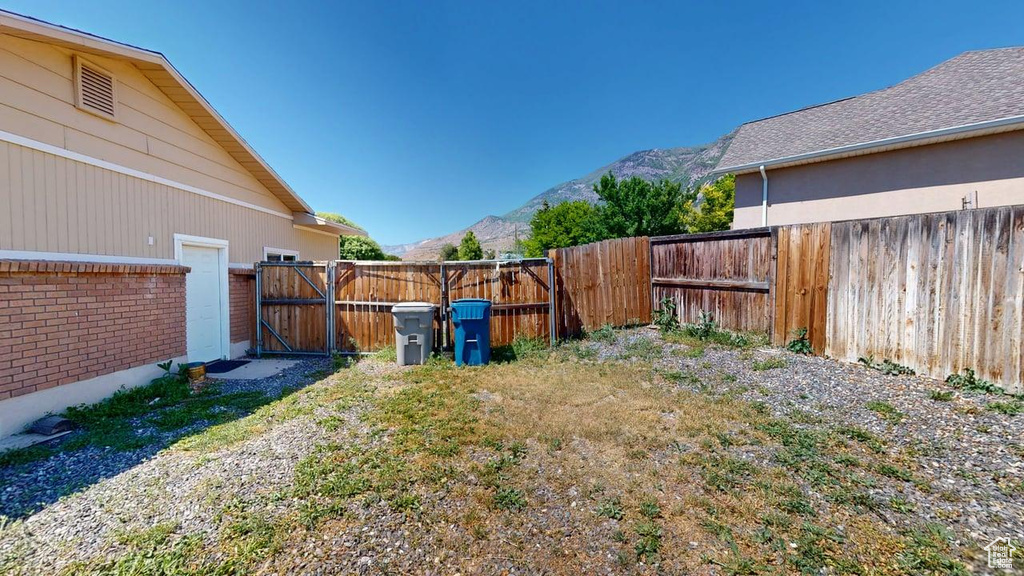 Fenced backyard featuring a mountain view