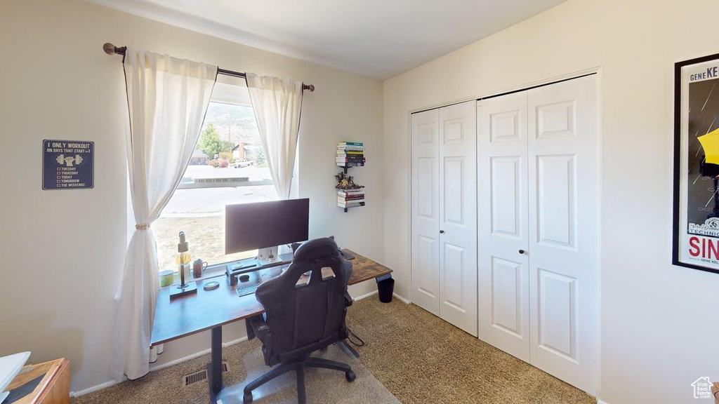 Carpeted office space with baseboards