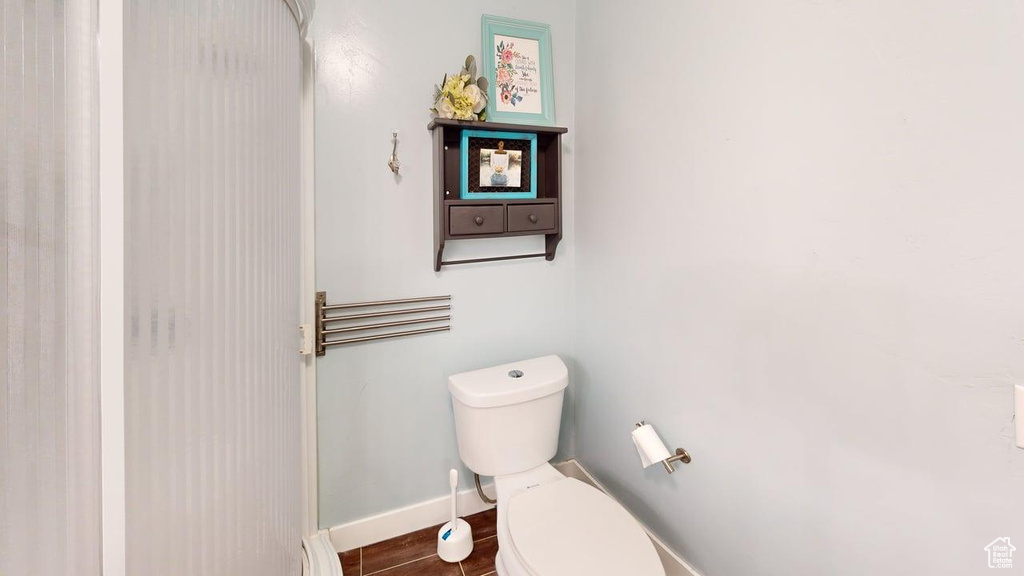 Bathroom featuring toilet and baseboards