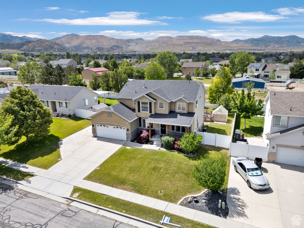 Aerial view of residential area featuring a mountainous background